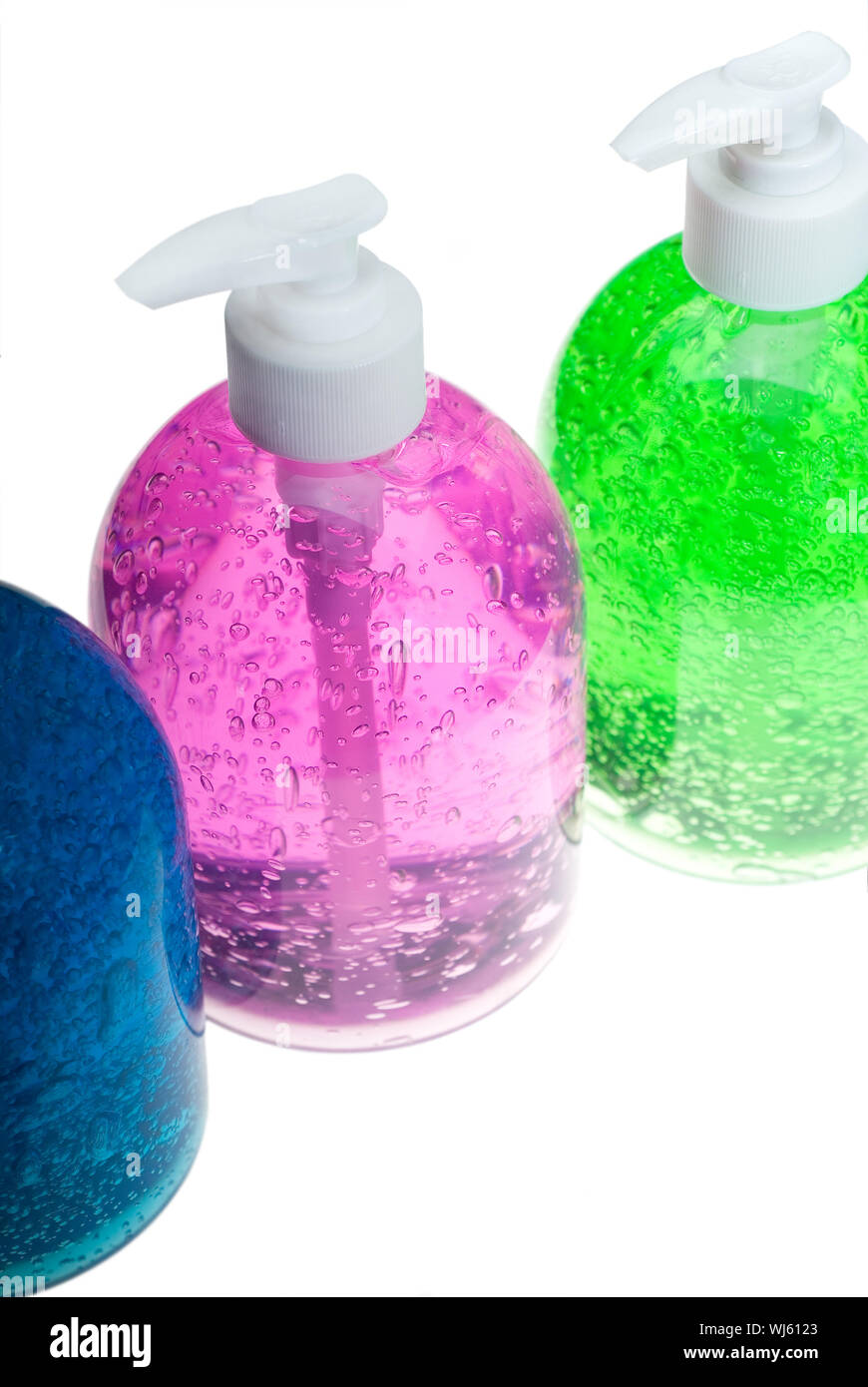 farbenfrohe blau, rosa und grünen Haar gel Flaschen auf weißem Hintergrund Stockfoto