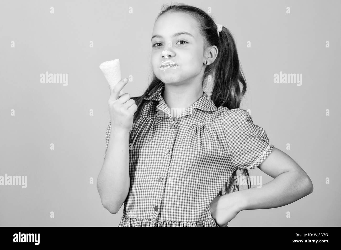 Der Sommer ist da. Mädchen Kind essen Eis beige Hintergrund. Leckeres Eis. Glückliche Kindheit. Sorglos kid süßen Eis genießen. Internationalen Tag der Kinder. Sweet Tooth Konzept. Stockfoto