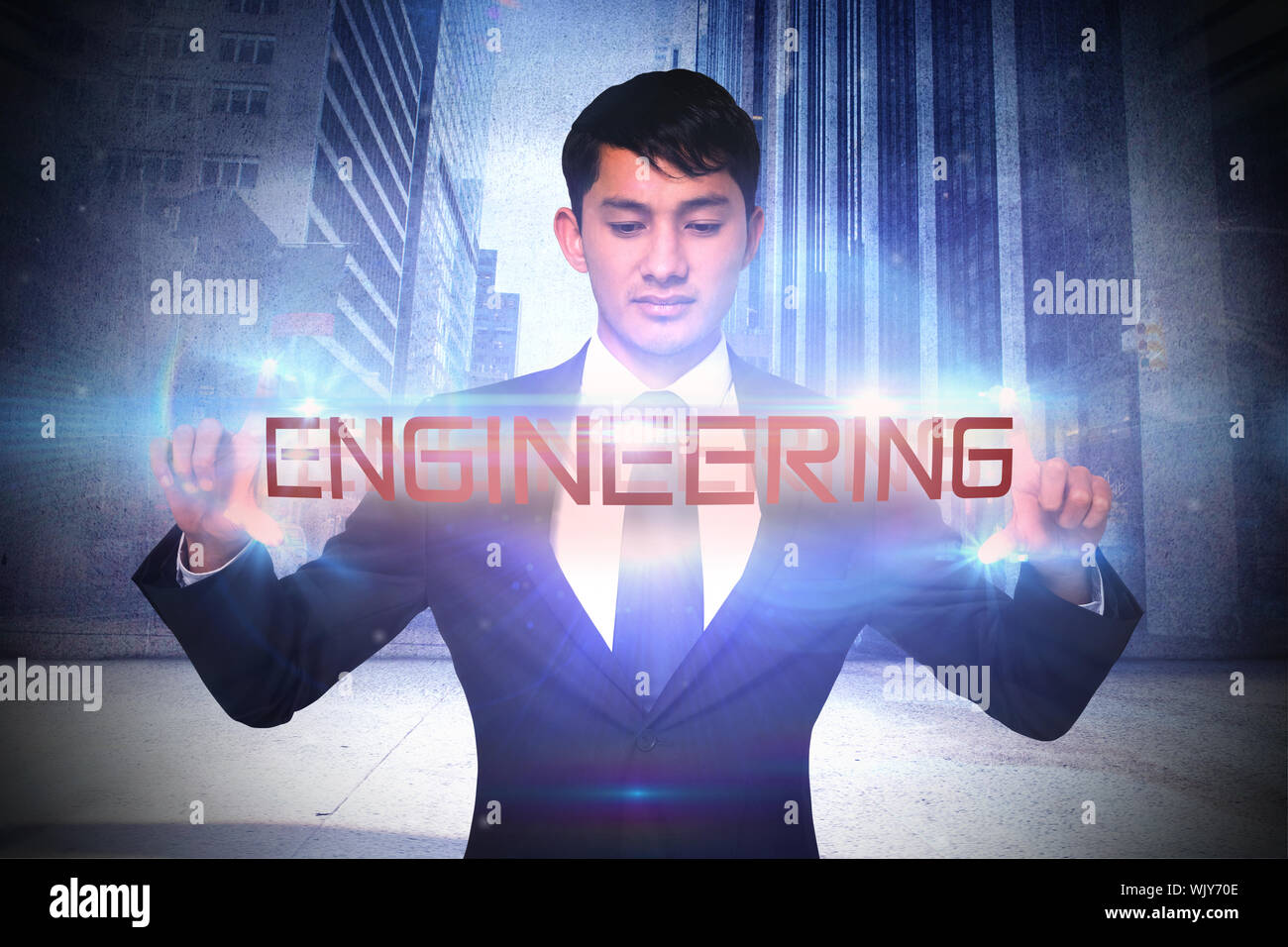 Das Wort engineering und mürrisch Geschäftsmann Holding gegen glühende Strudel auf schwarzem Hintergrund Stockfoto