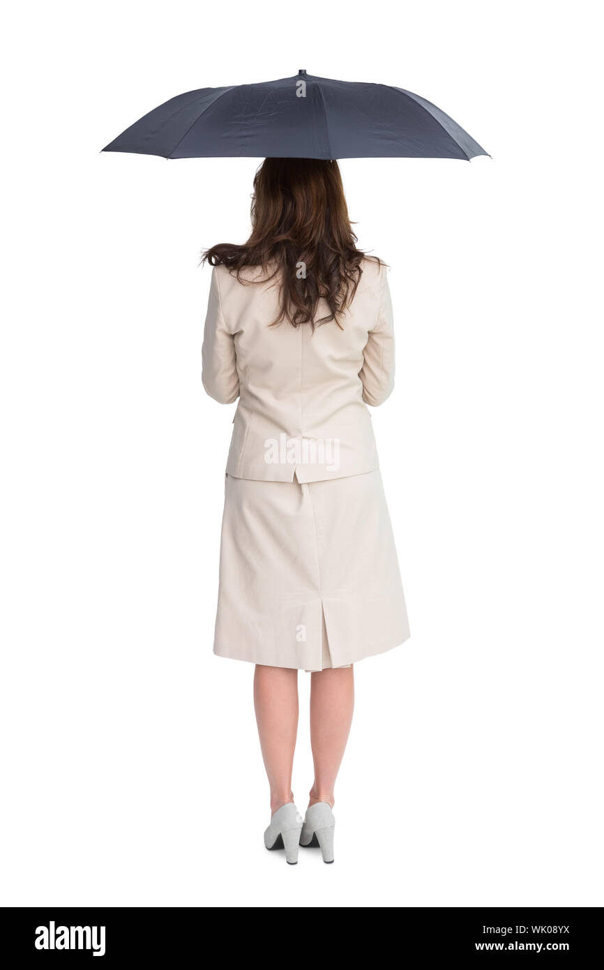 Rückansicht des edlen Geschäftsfrau hält Regenschirm Stockfoto