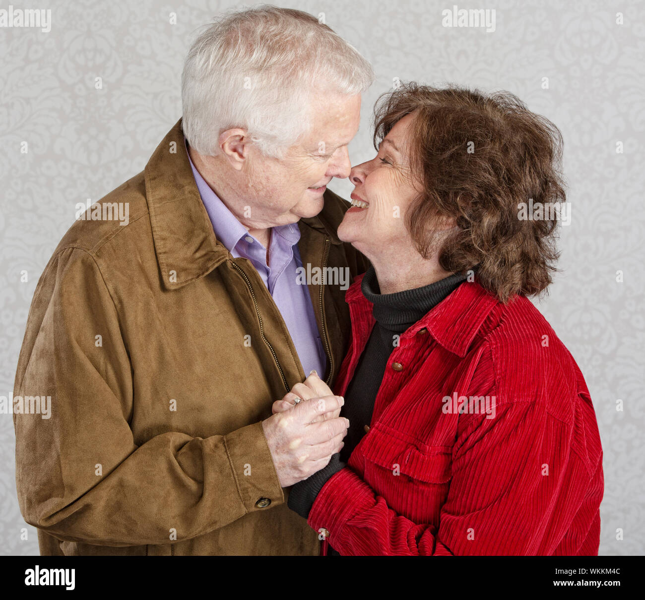 Älterer Mann und Frau küssen einander zu lieben Stockfoto