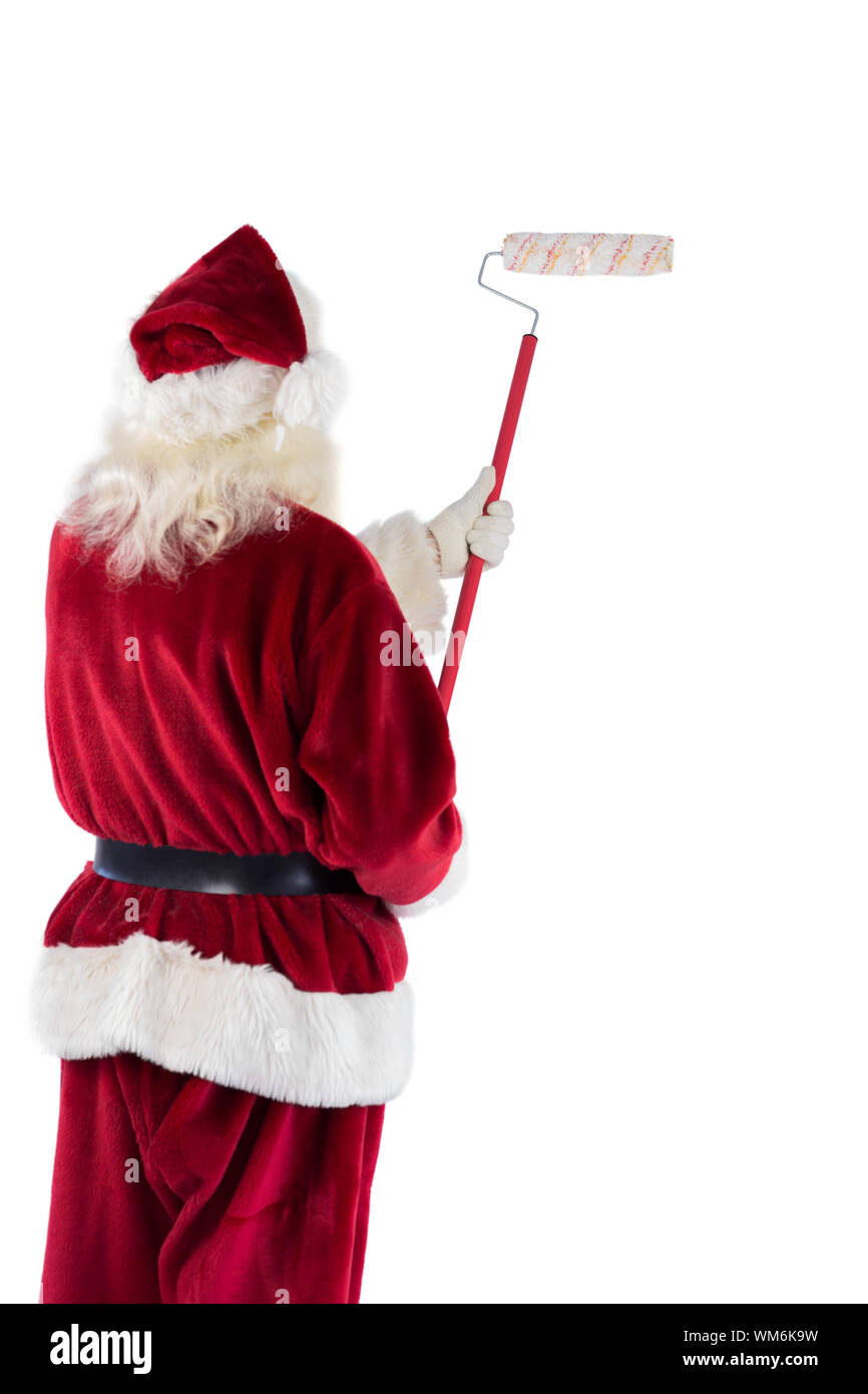 Weihnachtsmann malt die Wand weg von der Kamera Stockfoto