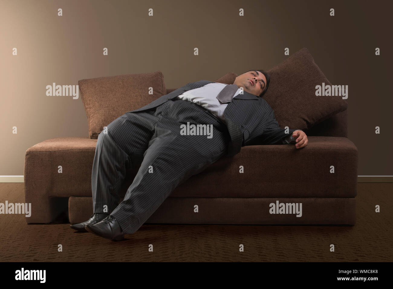 Beleibte Geschäftsmann in formelle Kleidung auf dem Sofa zu Hause schlafen Stockfoto
