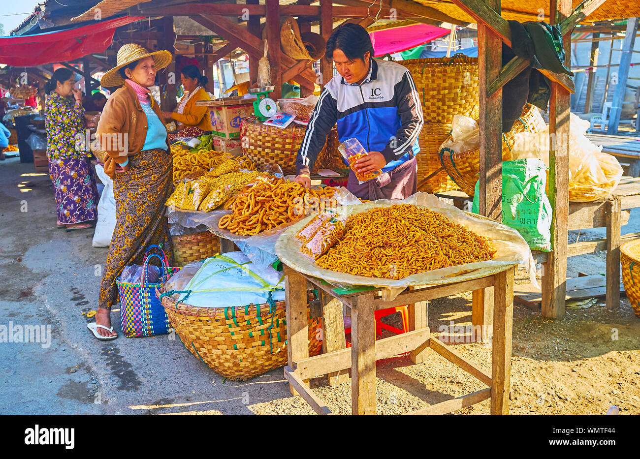 NYAUNGSHWE, MYANMAR - 20. FEBRUAR 2018: mingalar Marktstand bietet hausgemachte vermichelli, frittierter Brötchen und andere Backwaren, am 20. Februar in Nyaun Stockfoto