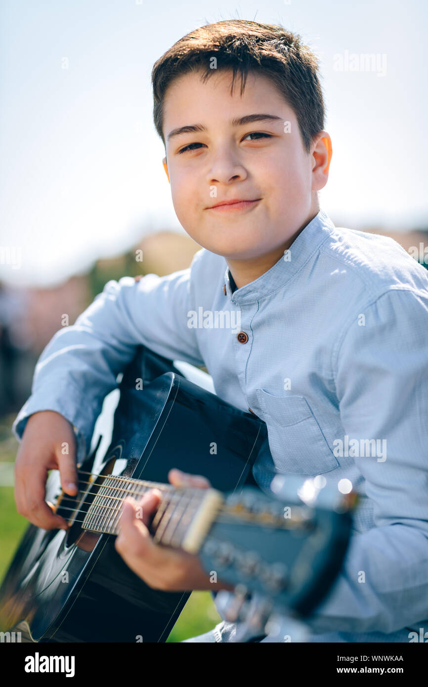 Junge nette Junge spielt Gitarre Stockfoto