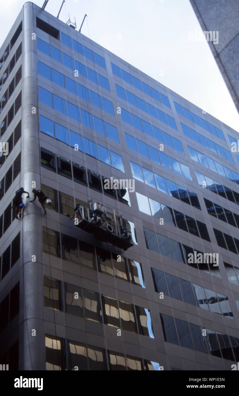 Hohes FENSTER & GEBÄUDE REINIGER BEI DER ARBEIT, Innere Stadt Büro Gebäude, Sydney, New South Wales, Australien. Stockfoto