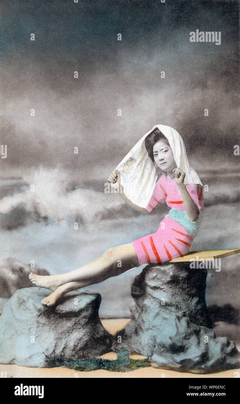 [1910s Japan - Japanische Frau in Badekleidung] - Ein studio Foto einer jungen Frau mit traditionellen Frisuren im Badeanzug posiert. Modelle für diese Art von Fotos, waren fast immer Geisha. 20. jahrhundert alte Ansichtskarte. Stockfoto