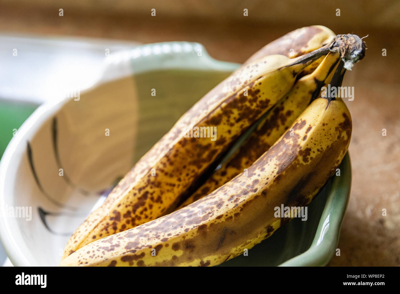 In der Nähe von reifen Bananen in dekorative Schale auf der Arbeitsplatte in der Küche Stockfoto