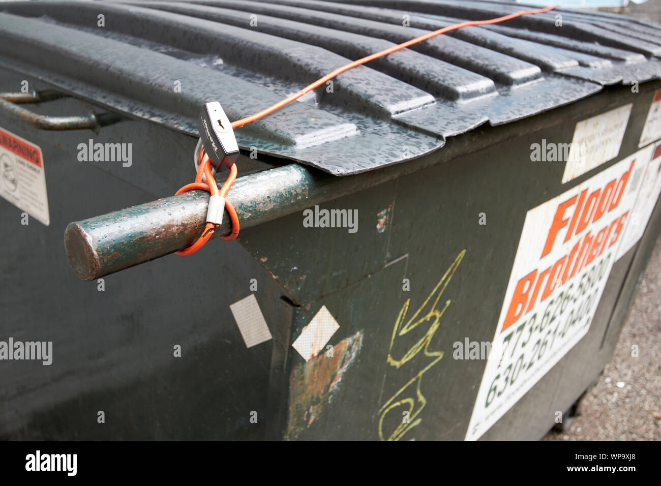 Kabel und einem Vorhängeschloss sichern den Deckel von einem Müllcontainer in Chicago Illinois USA Stockfoto