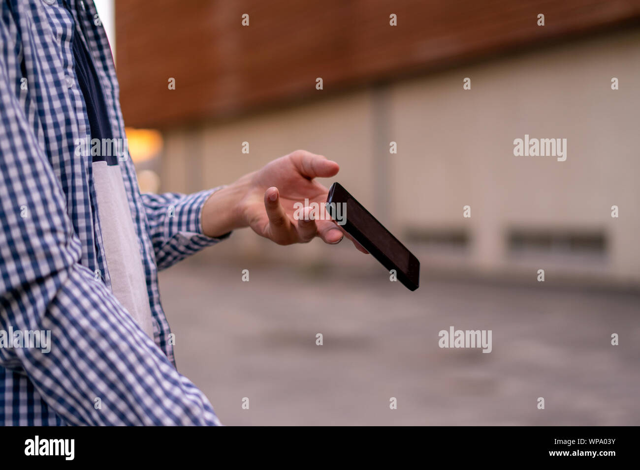 Person, die ein Smartphone auf der Straße, ein Telefon zu fallen und Sie fliegen von einem Unfälle Stockfoto