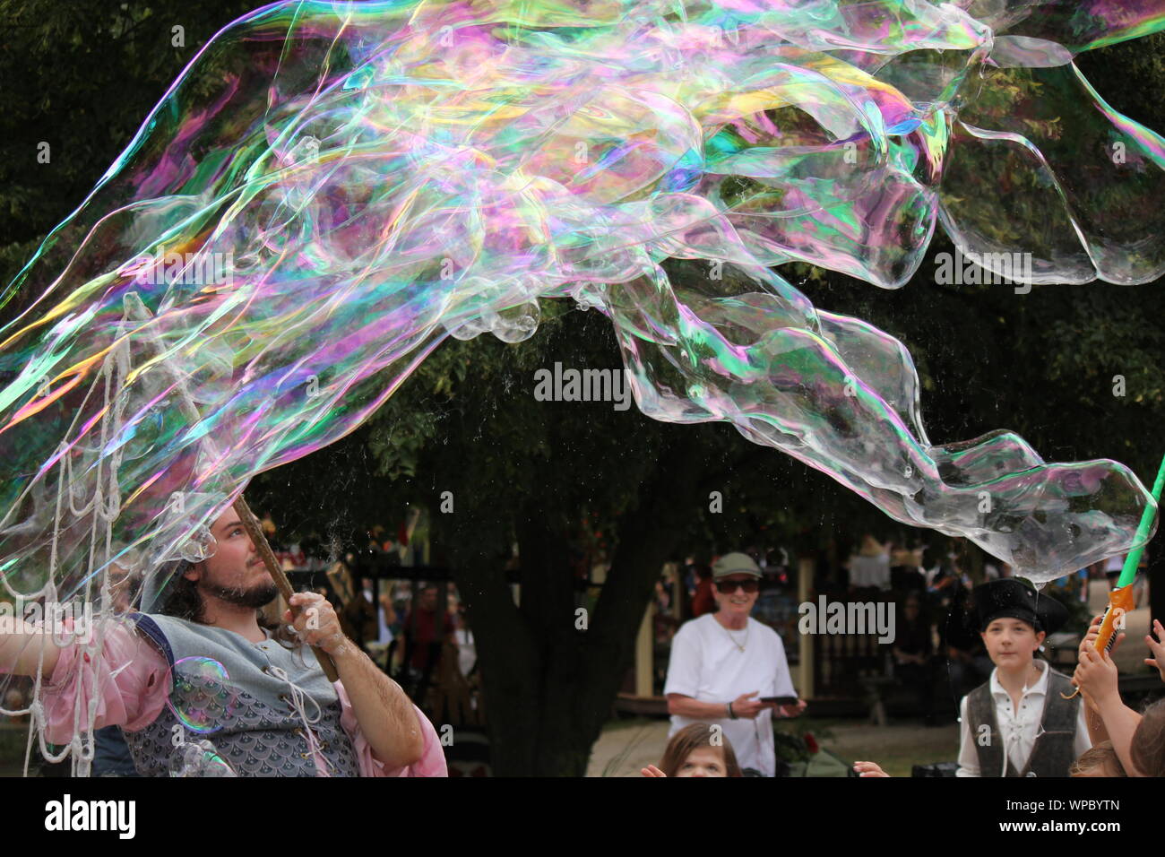 Die Blase Mann unterhalten Kinder einfache bläst Seifenblasen im Bristol Renaissance Faire und Fayre, Mittelaltermarkt, mercats Medievals. Stockfoto