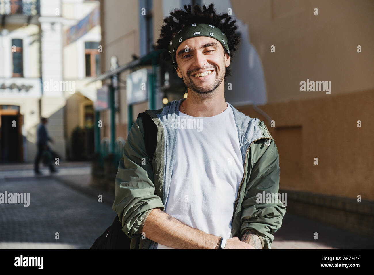 Lächelnd schöner Mann, glücklich hipster Kerl mit Dreadlocks Frisur im Freien in der Stadt Straße posieren. Rastafari Lebensweise. Close up Portrait von man d Stockfoto