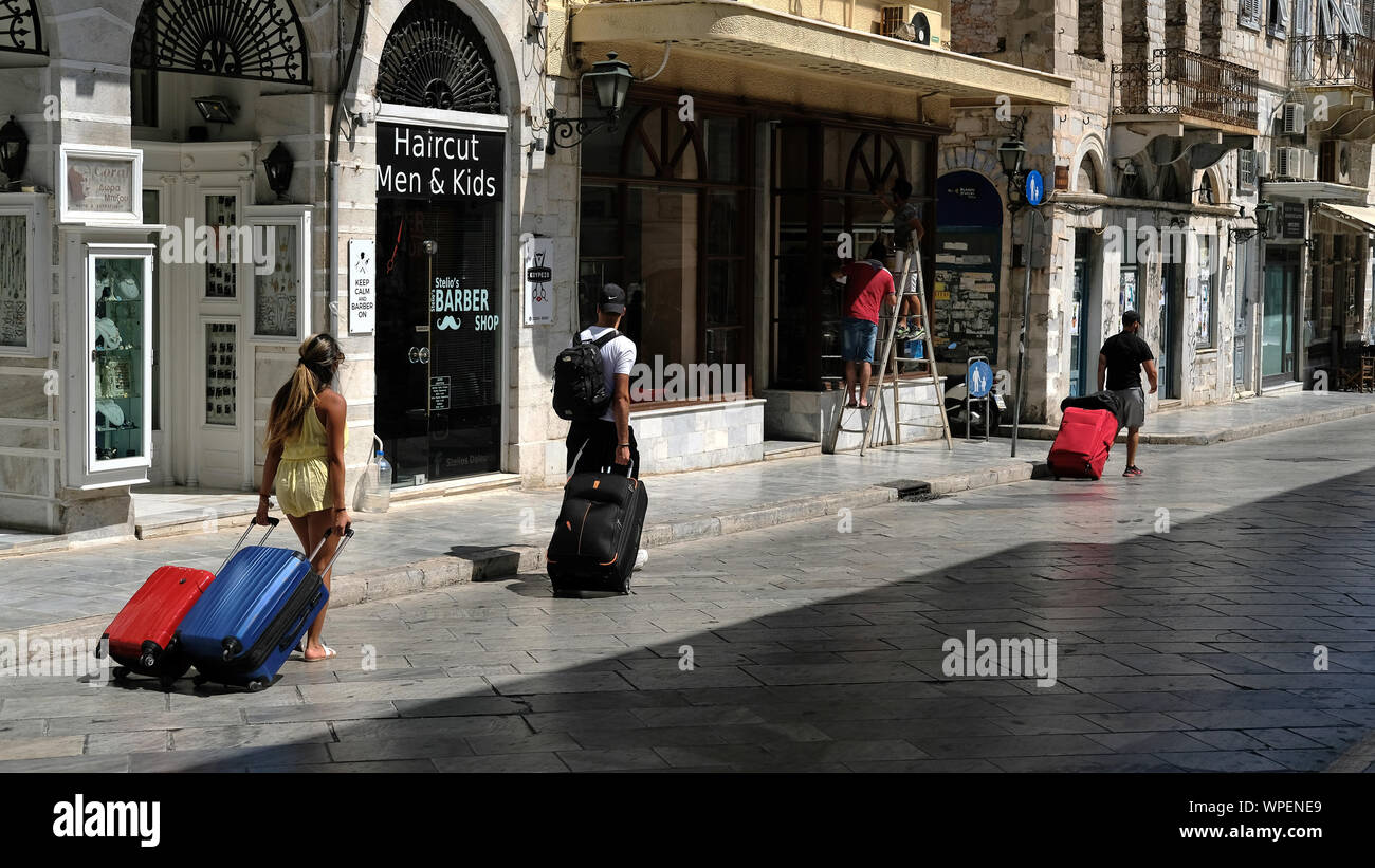 Touristen, die ihre Fälle über Syros, Griechenland. Stockfoto