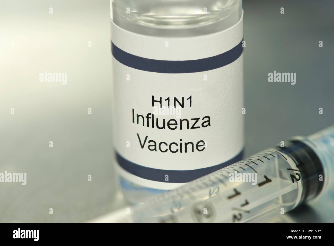 Der Grippe H1N1-Impfstoff auf silbernem Tablett mit Spritze. Stockfoto