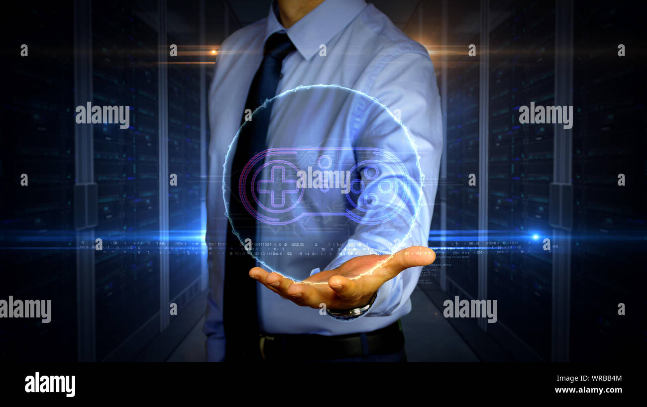Mann mit dynamischen Game pad Symbol Hologramm auf der Hand. Geschäftsmann und futuristisches Konzept des Gaming, 5G, Spielen und Online Spiel mit Licht und glitch Wirkung Stockfoto