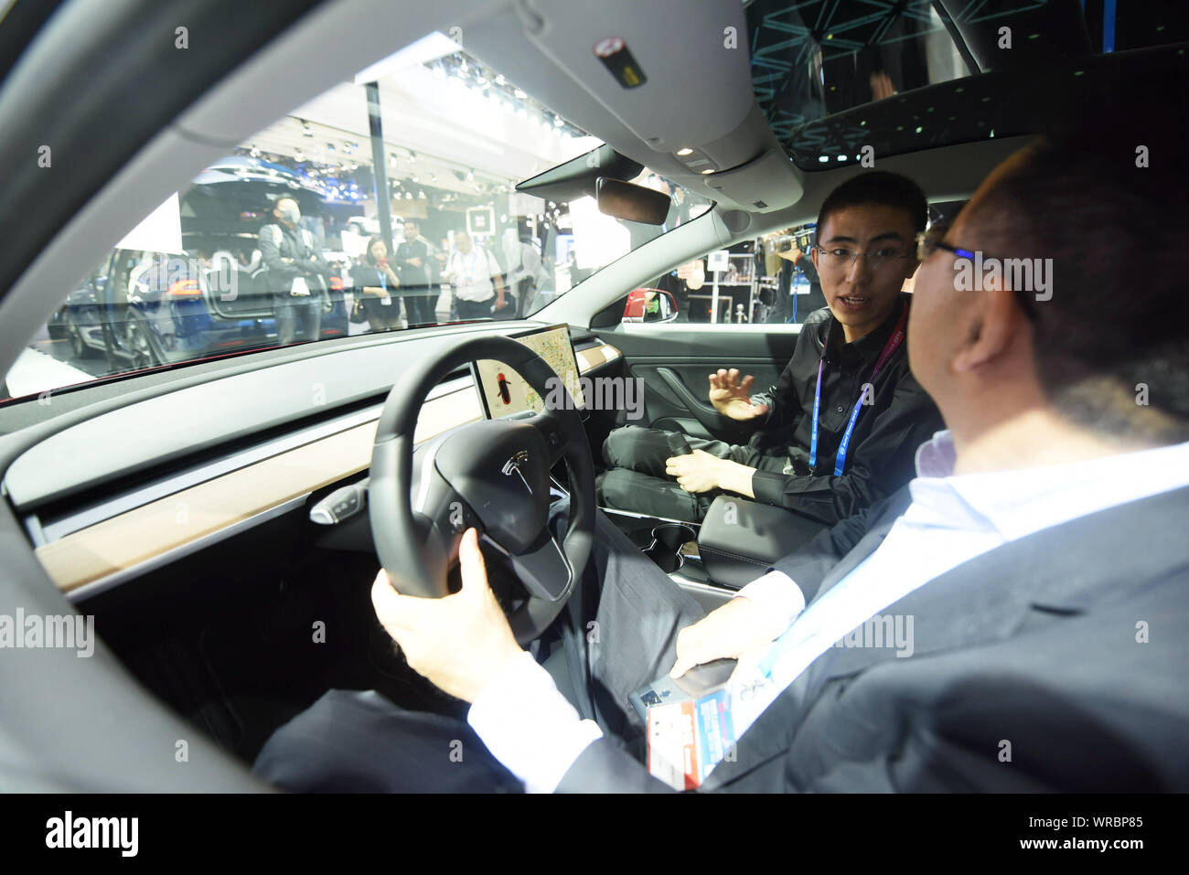** Datei ** Besucher Ausprobieren ein Tesla Modell 3 Elektroauto auf dem Display während der 15. Internationalen Automobil- Ausstellung (Auto China 2018) in Beij Stockfoto