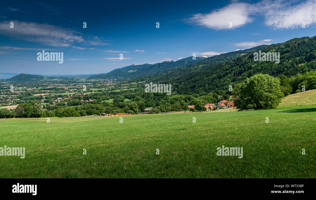 Berg Hügel überwucherten Landschaft mit Wäldern und Landhäuser mit blauer Himmel, Schwerpunkt auf Landhäuser. Haute-Savoie in Frankreich. Stockfoto