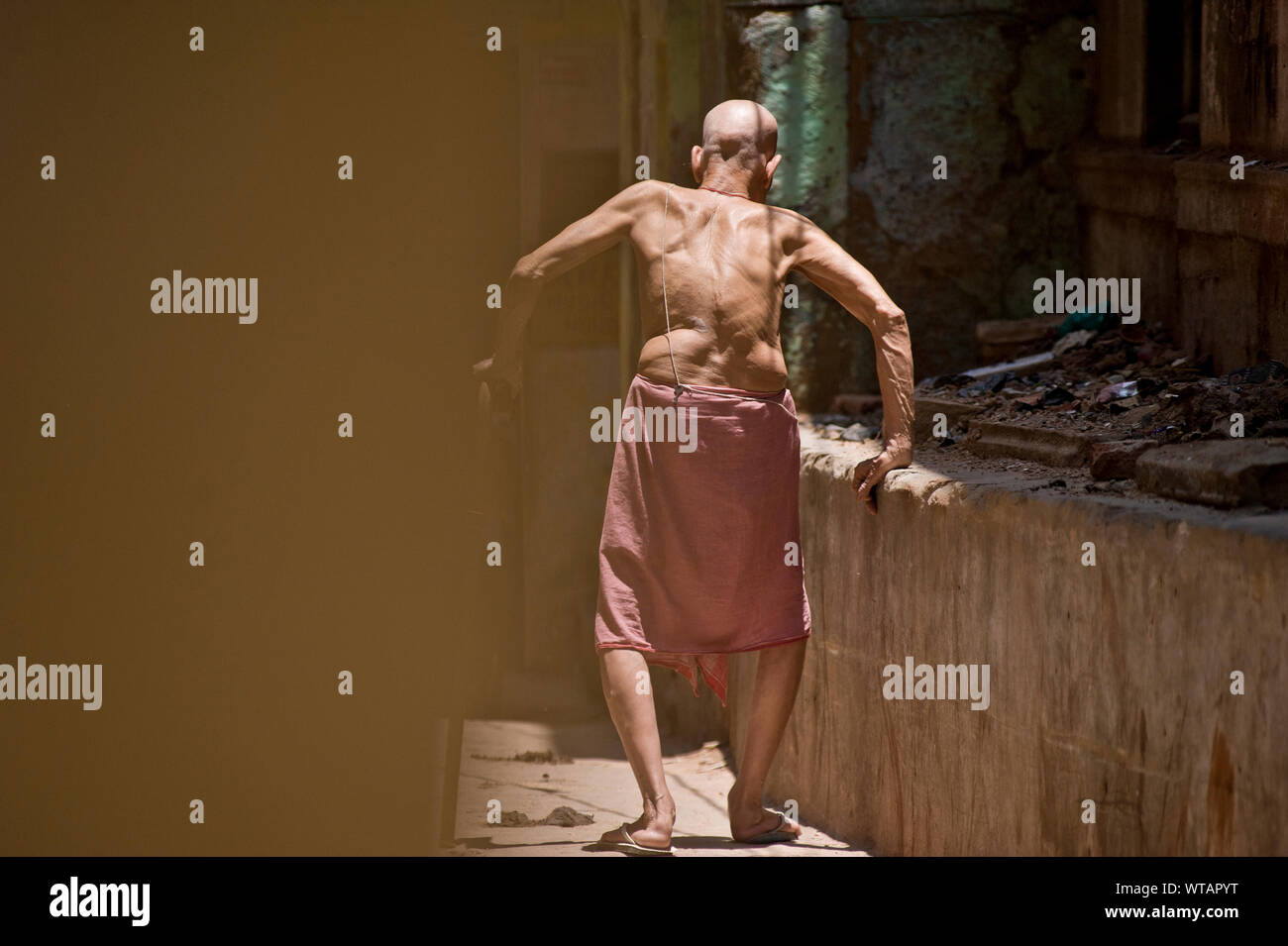 Alter Mann zu Fuß in den Straßen von Varanasi Stockfoto