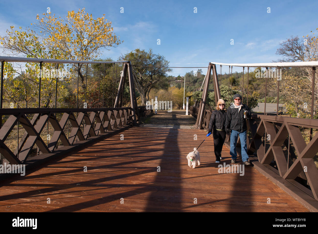 Michelle und Bill Gentry (und Ihren vierbeinigen Freund) überqueren Sie die ursprünglichen Folk Bar Bridge über den See Oroville, eine künstlich angelegte Stausee erstellt durch das Aufstauen der Feather River über Oroville, Kalifornien Stockfoto