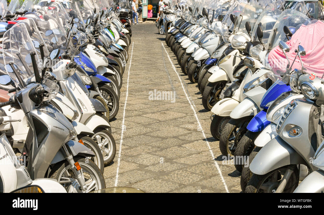 SORRENTO, ITALIEN - AUGUST 2019: Reihen von Motorräder und Motorroller in der Nähe des Hafen in Sorrento geparkt. Stockfoto