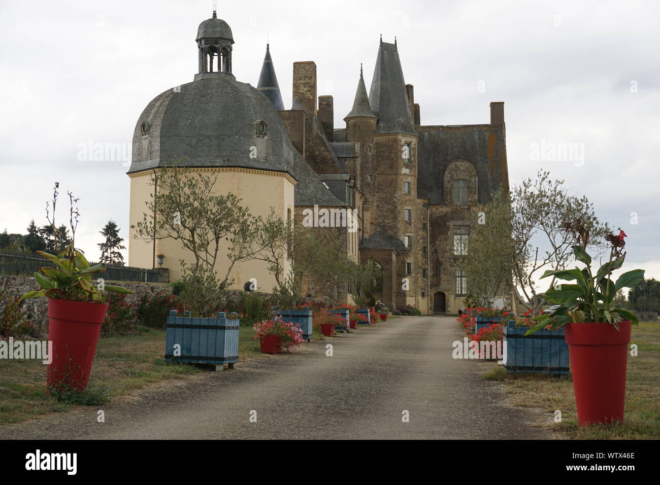 Bunte Blumentöpfe entlang der Spur führt zu dem kleinen Land Schloss in Frankreich Stockfoto