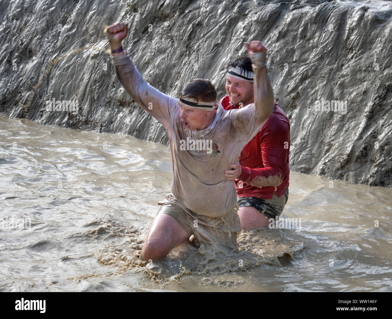 Wettbewerber gekleidet, wie England und Wales Rugby Spieler auf der 'Mud Mile' an der haltbaren Mudder Ausdauer Event im Badminton Park, Gloucestershire, Großbritannien Stockfoto