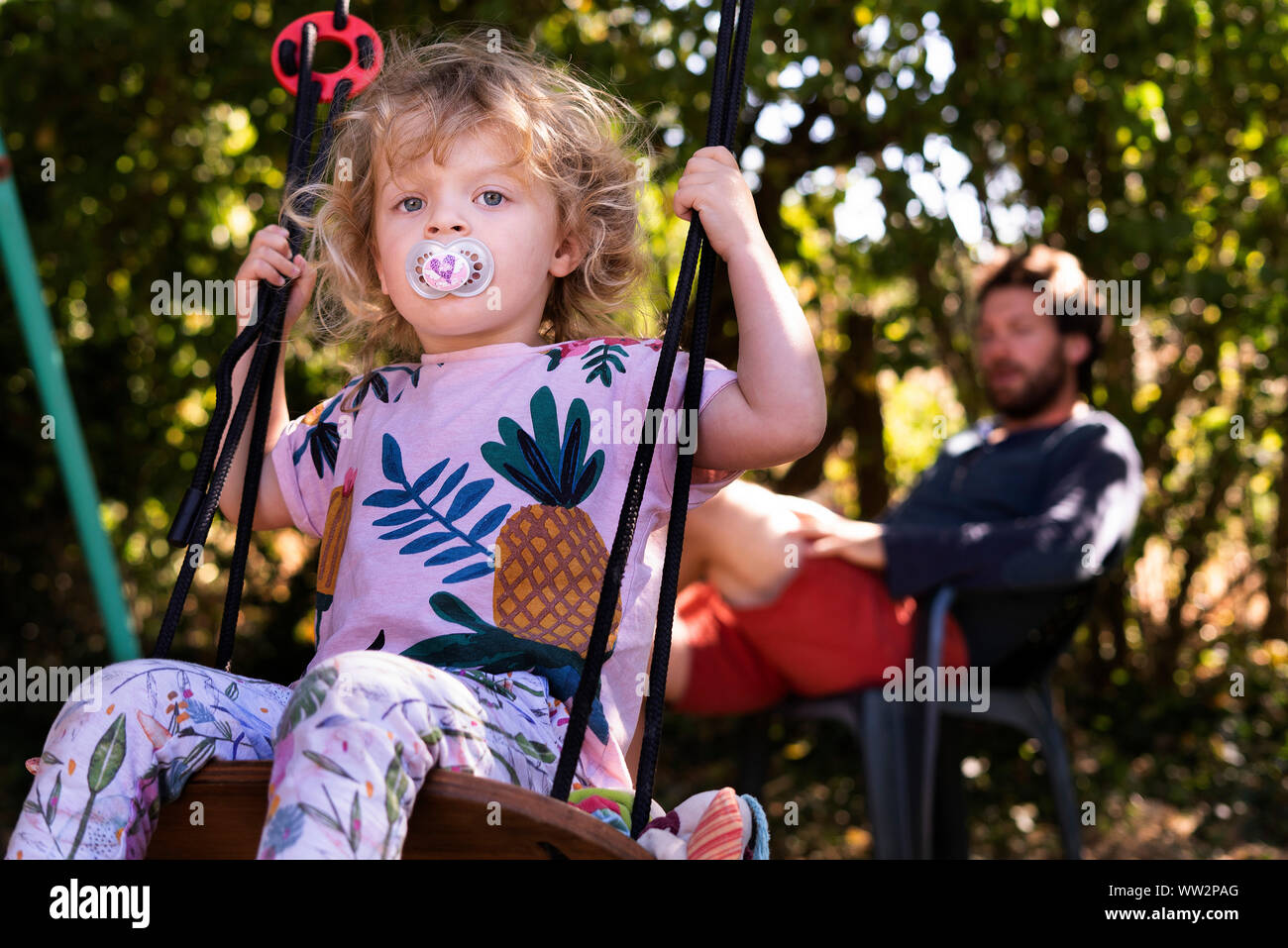 Kleines Mädchen schwingen auf Swing Stockfoto
