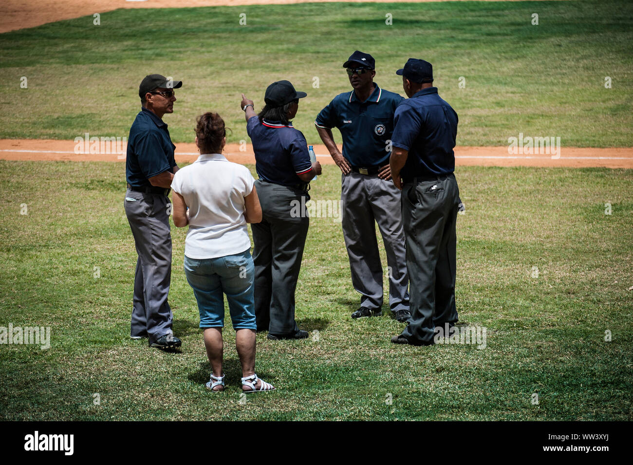 Die Reiche, eine davon weiblich, versammeln sich während eines Baseballspiels in Havanna, Kuba Stockfoto