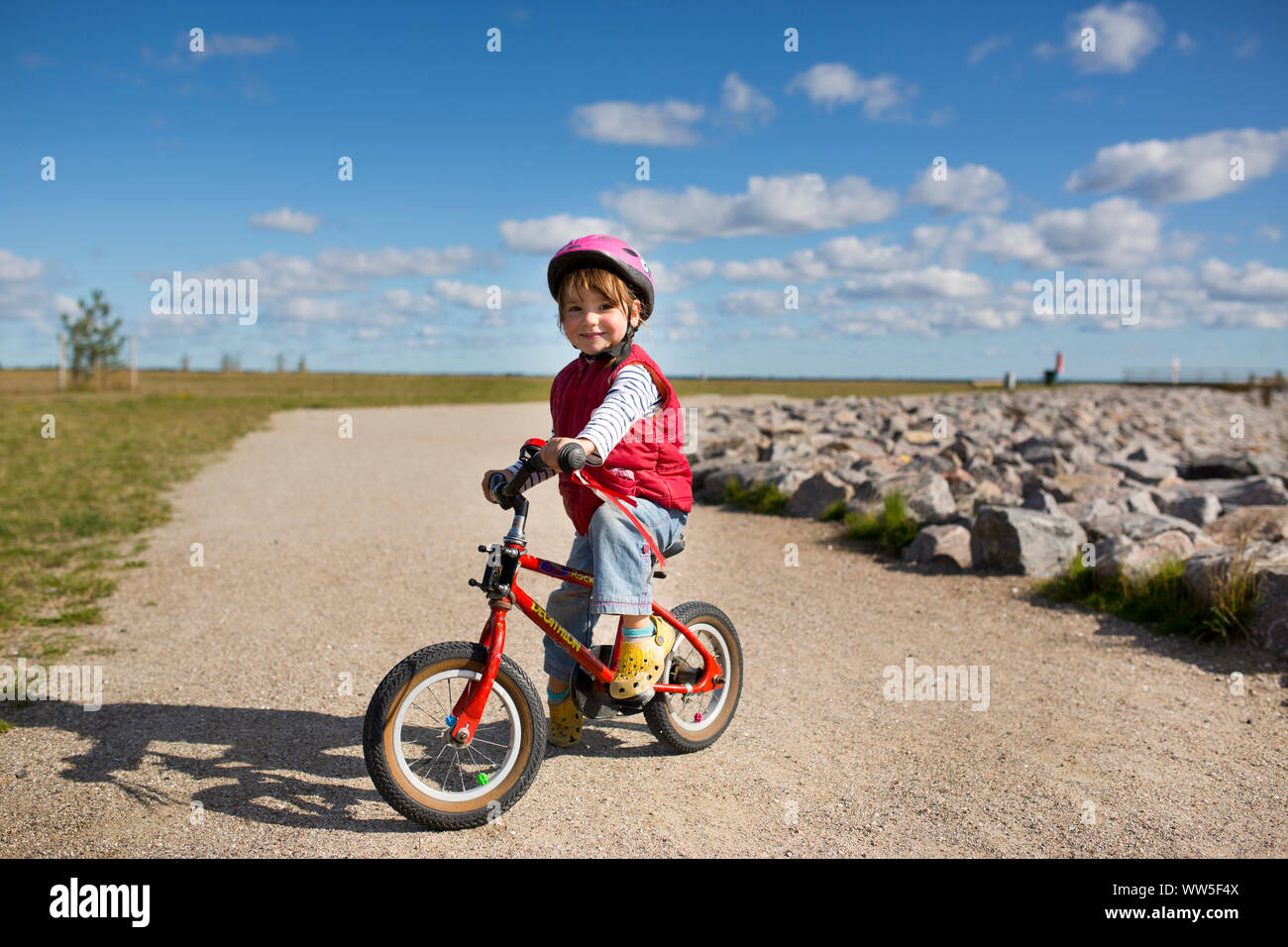 4-6 Jahre altes Mädchen reiten red Kinder Fahrrad auf eine Art und Weise an der Ostsee Stockfoto