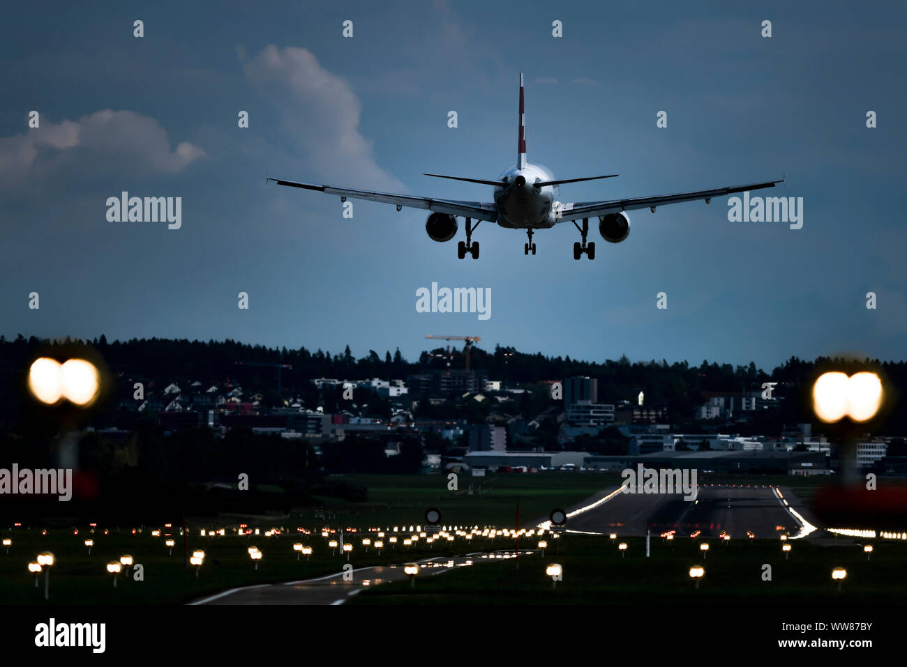 Schweizer Maschine Landeanflug mit Landing Strip Lights, Flughafen Kloten, Zürich, Schweiz Stockfoto