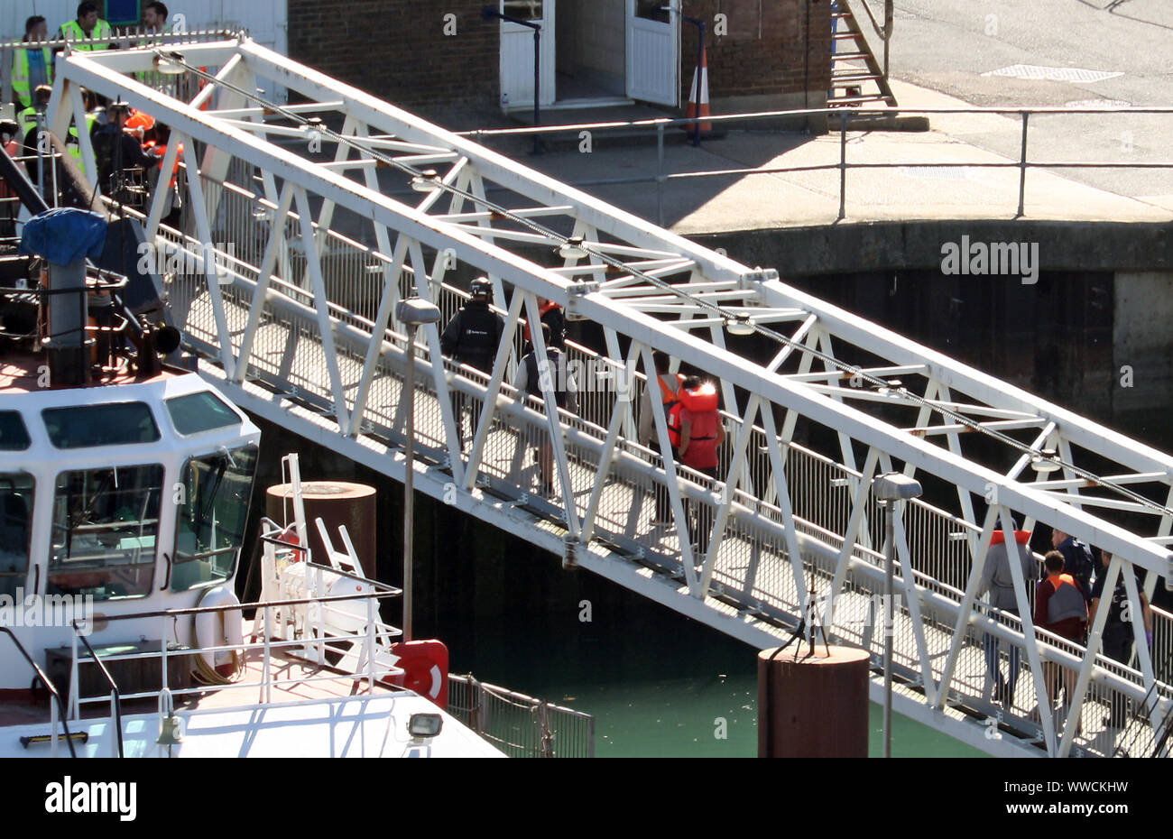 Eine Gruppe von Männern gedacht, um Migranten werden zu Ufer durch Grenze Offiziere im Hafen von Dover, Kent nach einer Reihe von kleinen Boot Zwischenfälle in den Kanal am Sonntag. Stockfoto