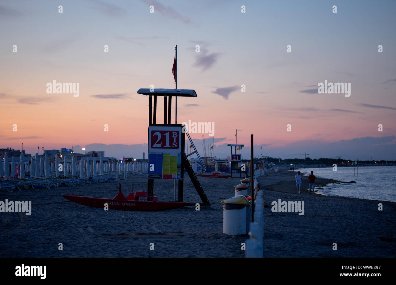 Sottomarina di Chioggia, Italien - 16. Juni 2019: Sonnenuntergang in der Sandstrand mit Blick auf das Meer, die Rettung Tower, Kite Surfer, Meer. Stockfoto