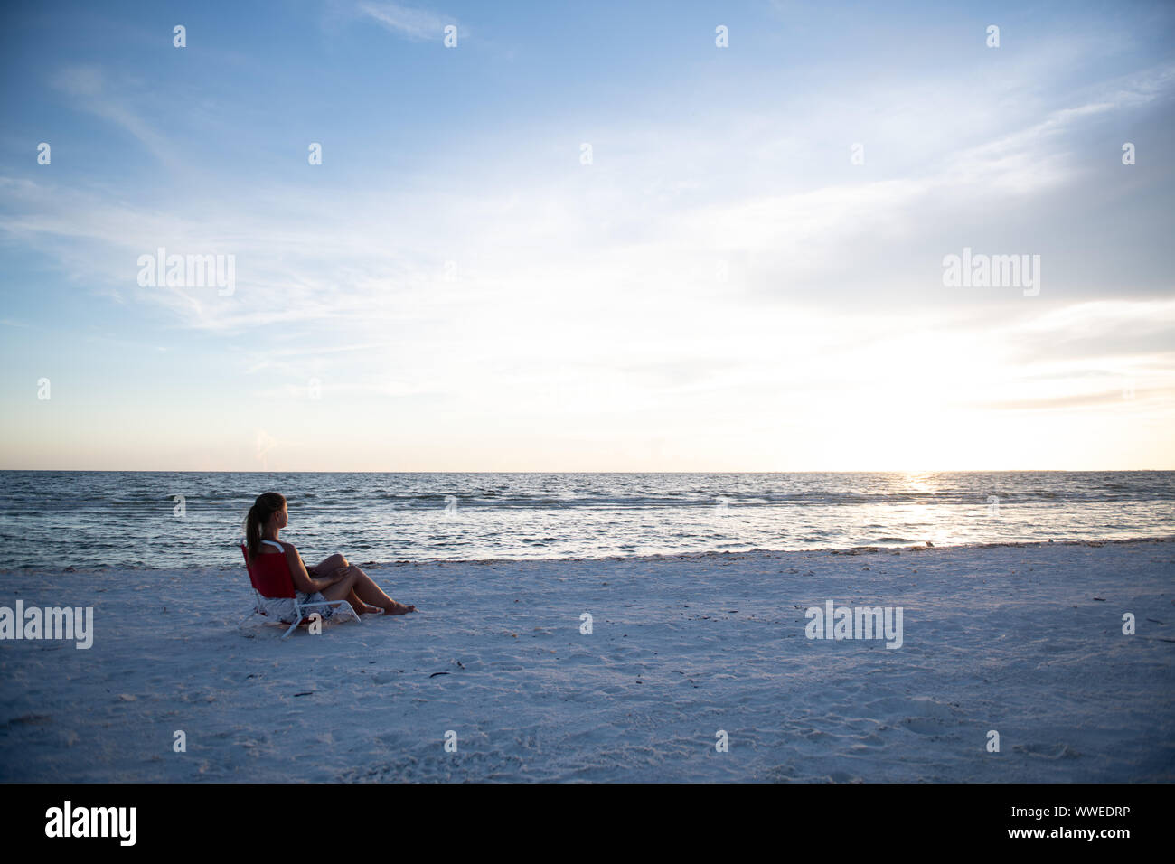 Junge Frau am Strand bei Sonnenuntergang in Florida suchen, USA Stockfoto