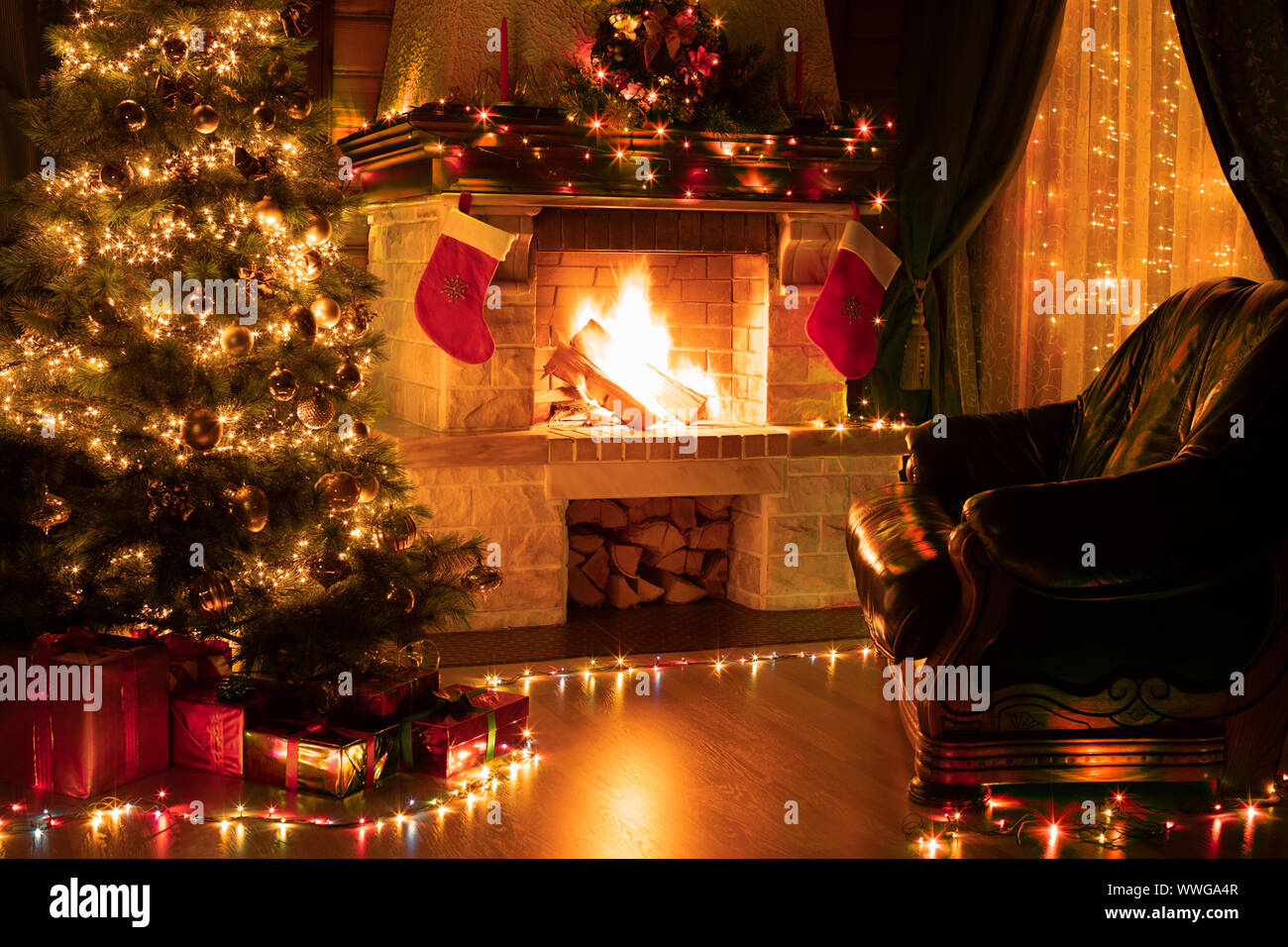 Weihnachten Wohnzimmer Einrichtung mit verzierten Kamin, Sessel und Xmas Tree Stockfoto