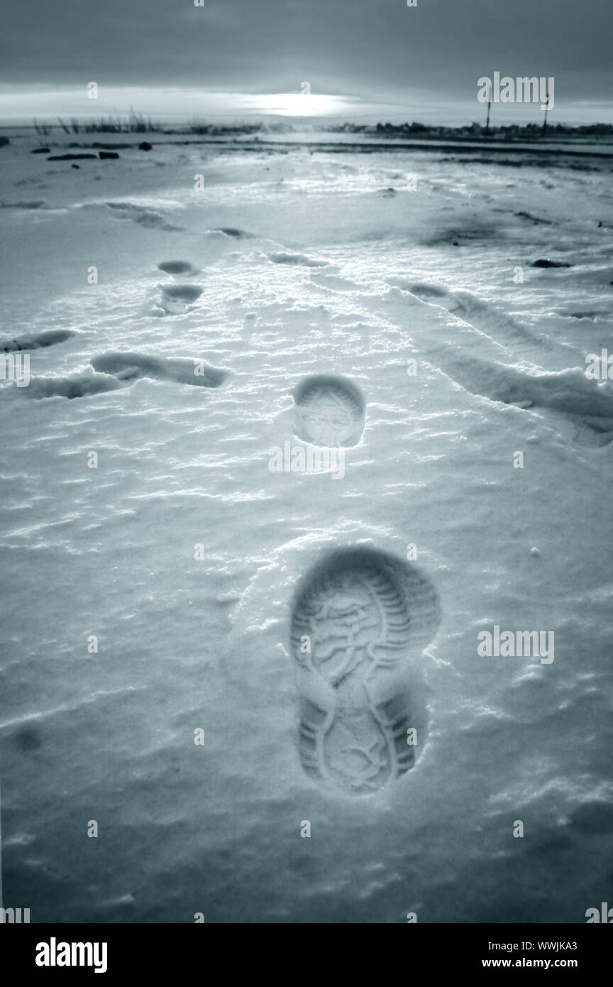 Footprint auf weißem Schnee Männer gehen zu Sun Stockfoto