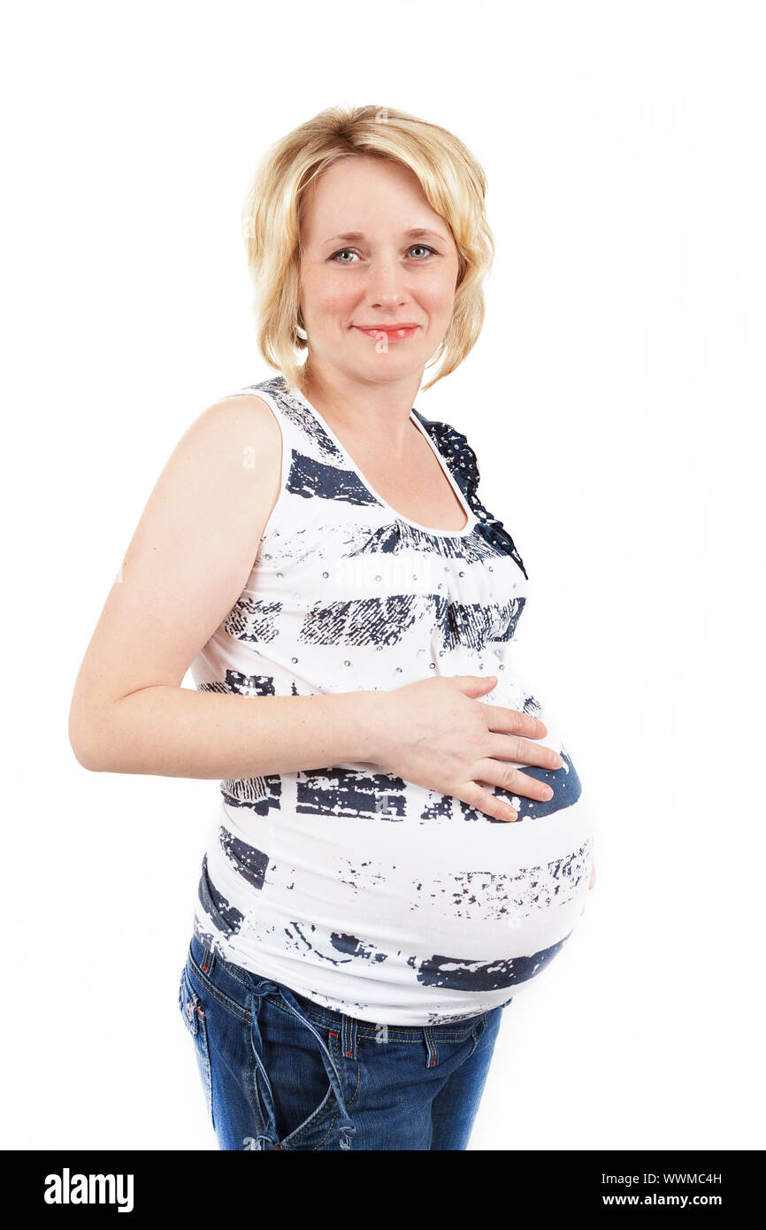 schöne schwangere Frau zärtlich hält ihren Bauch isoliert auf weißem Hintergrund Stockfoto