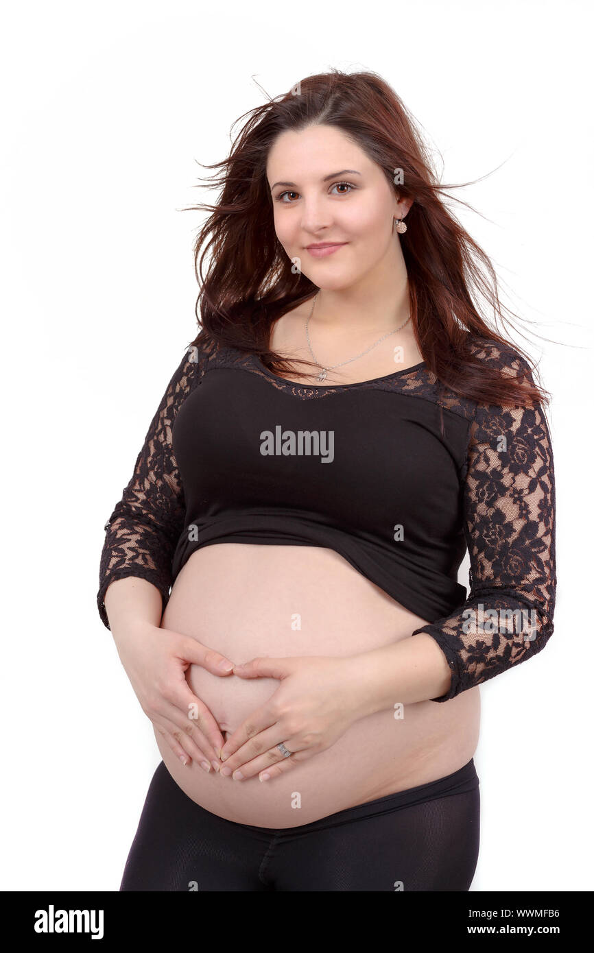 schöne schwangere Frau zärtlich hält ihren Bauch isoliert auf weißem Hintergrund Stockfoto