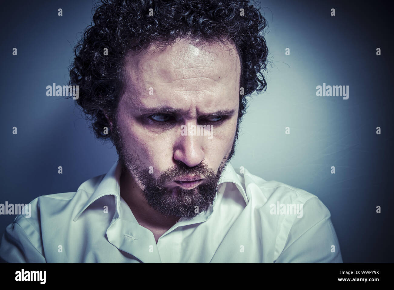 trauriges Gesicht, Mann mit intensiven Ausdruck, weißes Hemd Stockfoto