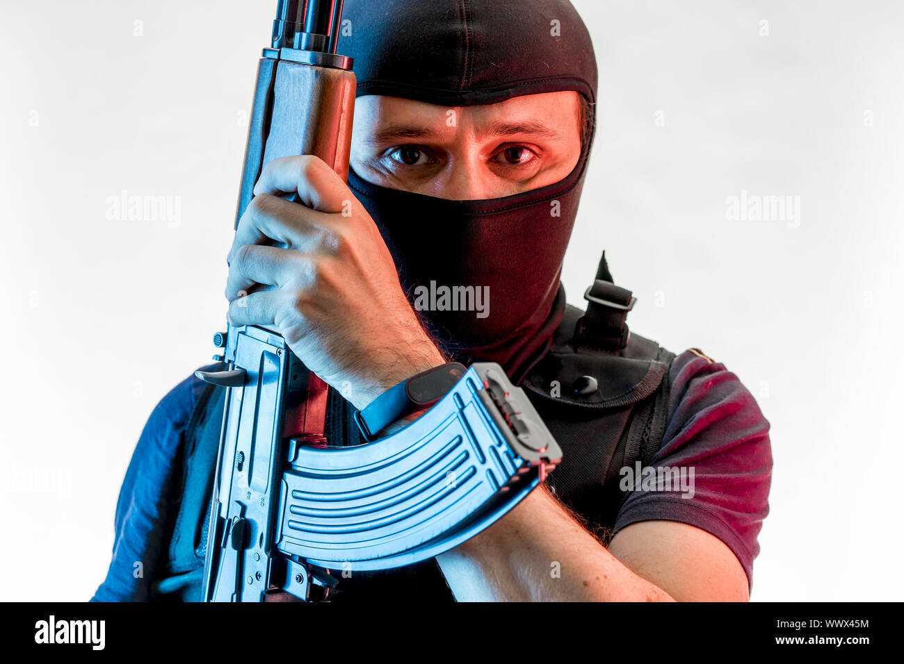 Bewaffneter Mann mit Sturmhaube und kugelsichere Weste, Pistole und Schrotflinte, kalaschnikow Stockfoto