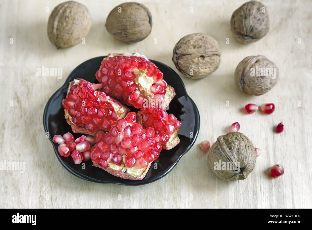 Granatapfel Obst auf den Teller und Walnüsse. Stockfoto