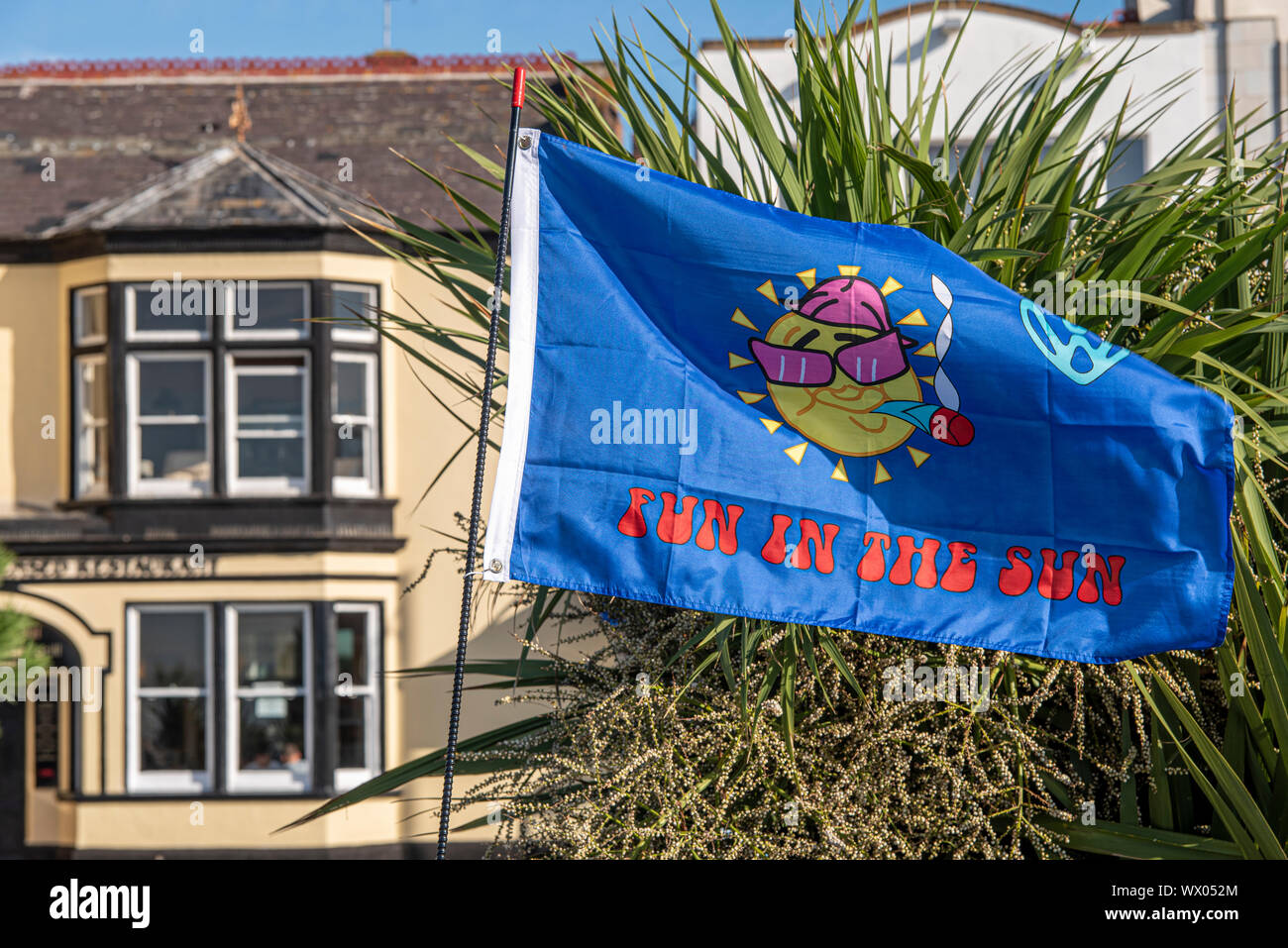 Spaß in der Sonne slogan Flagge auf der Marine Parade, Southend On Sea, Essex, Großbritannien an einem sonnigen Tag. Sun Bild mit Sonnenbrille und Zigarette, evtl. Unkraut Drogen Stockfoto