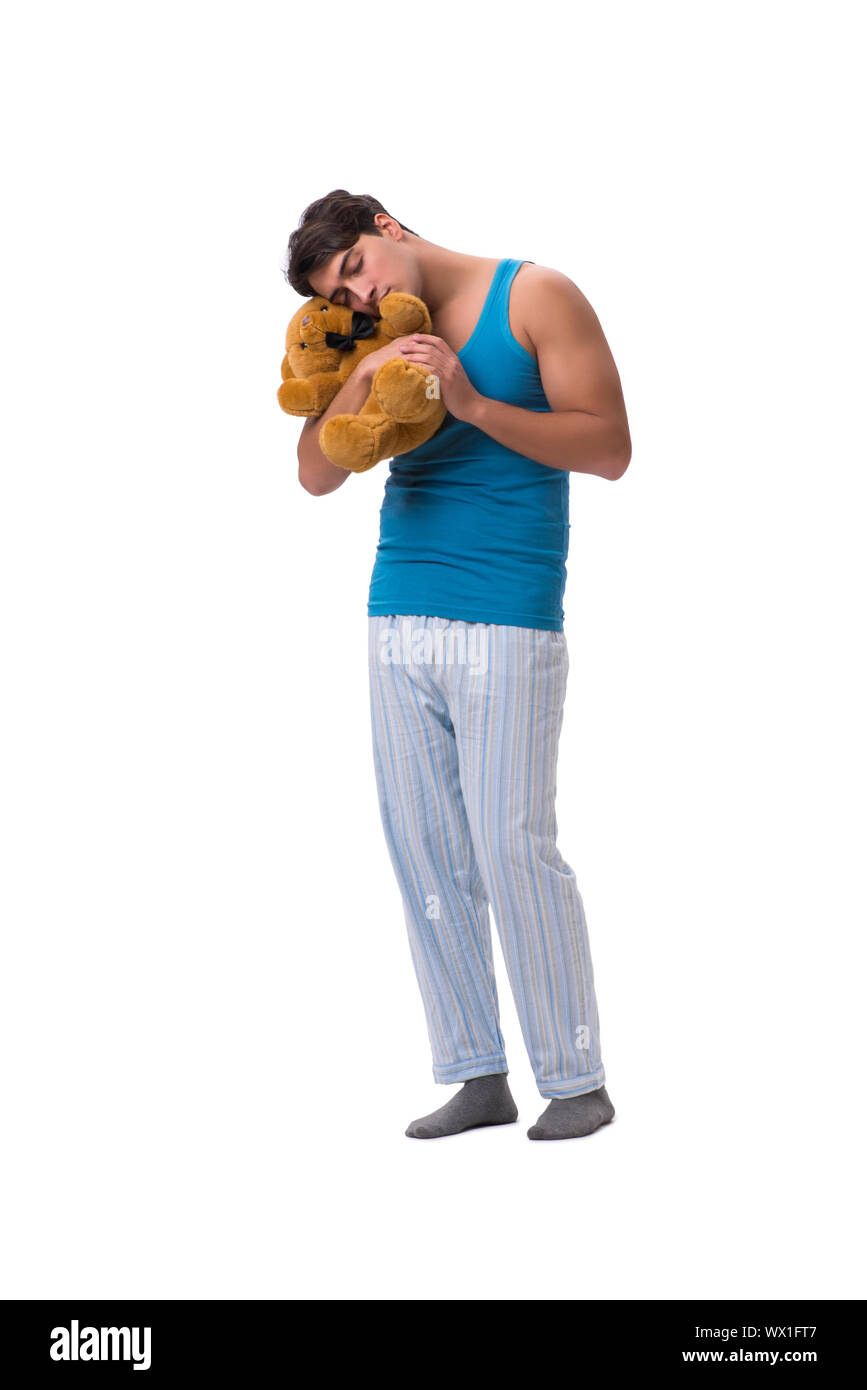 Junger Mann im Schlafanzug mit Spielzeug Tier isoliert auf weißem backgroun Stockfoto