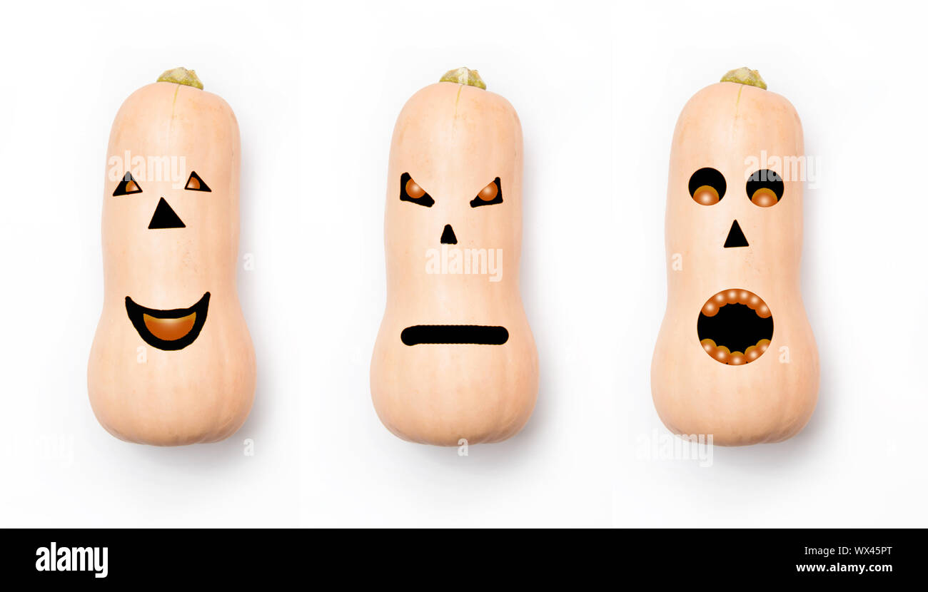 Drei Kürbisse mit unterschiedlichen Gesichtern auf einem weißen Hintergrund. Konzept für Halloween. Stockfoto