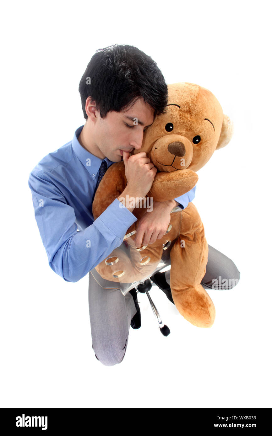Ein Geschäftsmann, einen Teddybär umarmt. Stockfoto