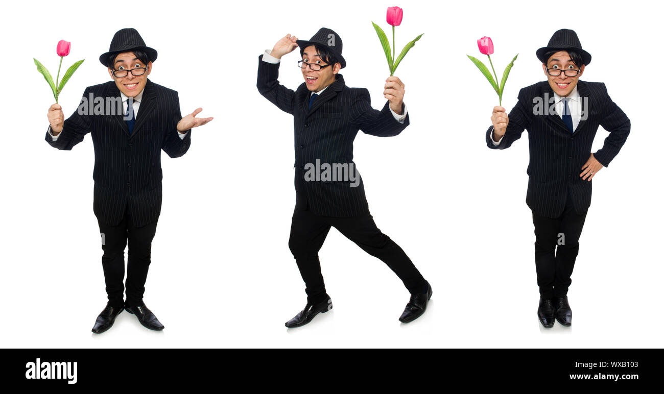 Junger Mann im schwarzen Kostüm mit Blume isoliert auf weiss Stockfoto