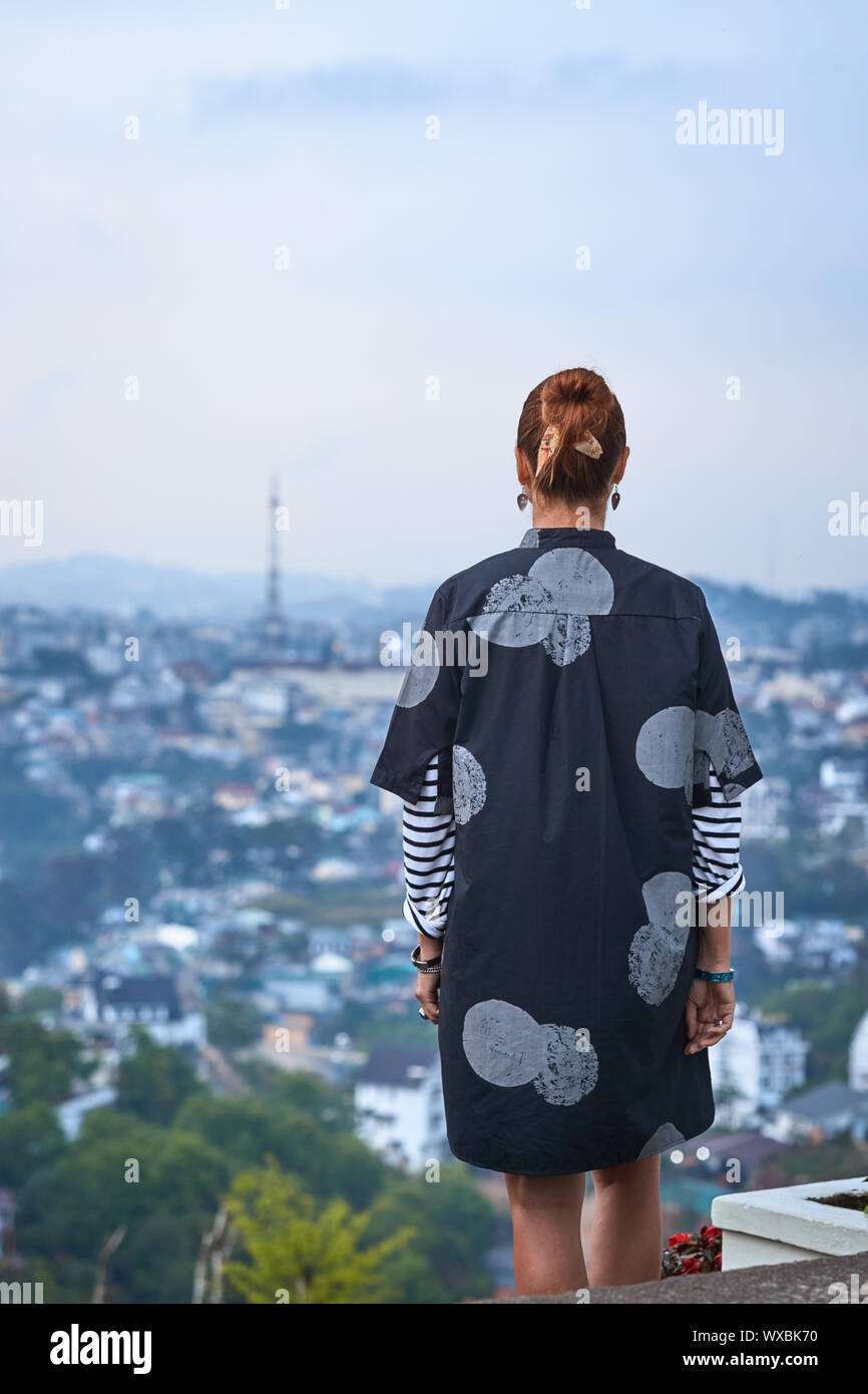 Frau mit Blick auf die Stadt, Dalat, Vietnam Stockfoto