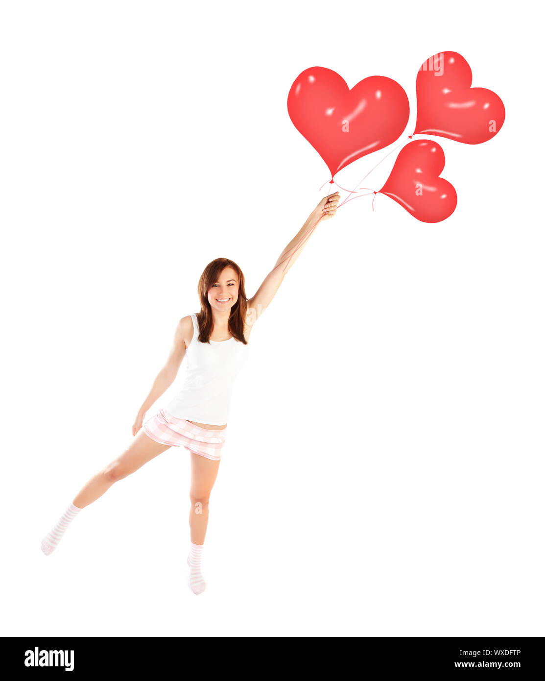 Bild von weiblich zu fliegenden roten herzförmigen Luftballons, lachende Frau auf weißem Hintergrund, Freiheit Lifestyle, Valentinstag, romantische Drea Stockfoto
