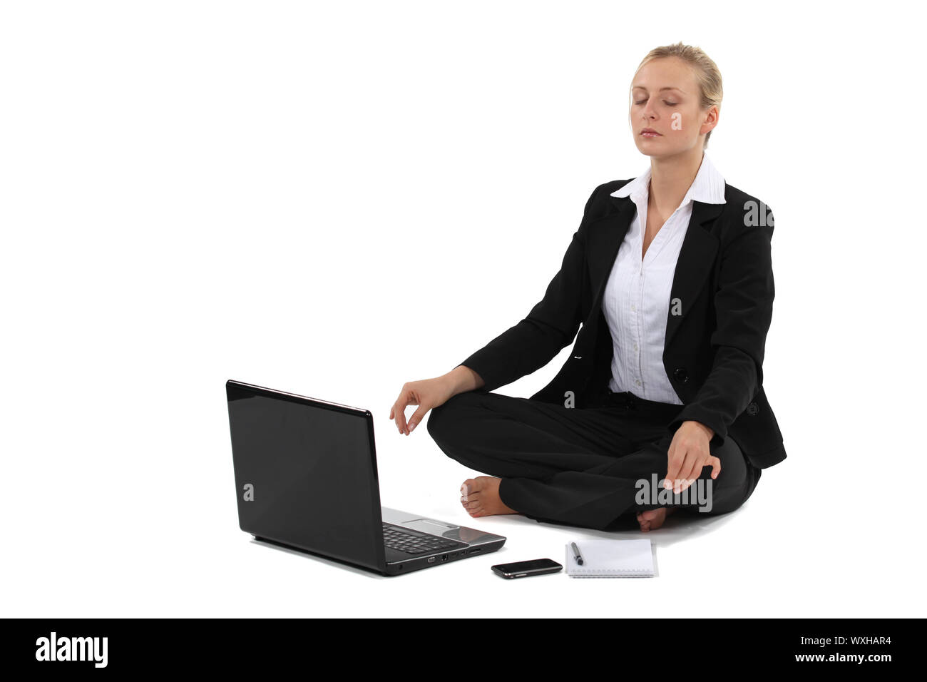 Geschäftsfrau in Yogaposition Stockfoto