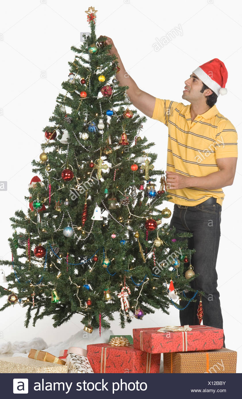 Man Einen Weihnachtsbaum Zu Schmucken Und Lachelnd Stockfoto Bild