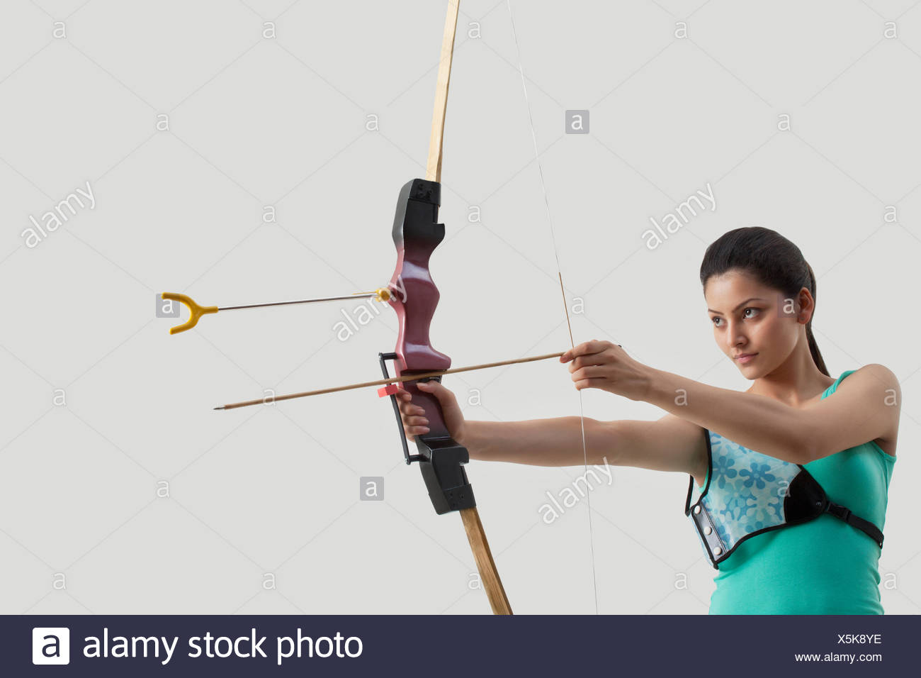 Weibliche Bogenschutzen Mit Dem Ziel Pfeil Und Bogen Gegen Grauen Hintergrund Stockfotografie Alamy